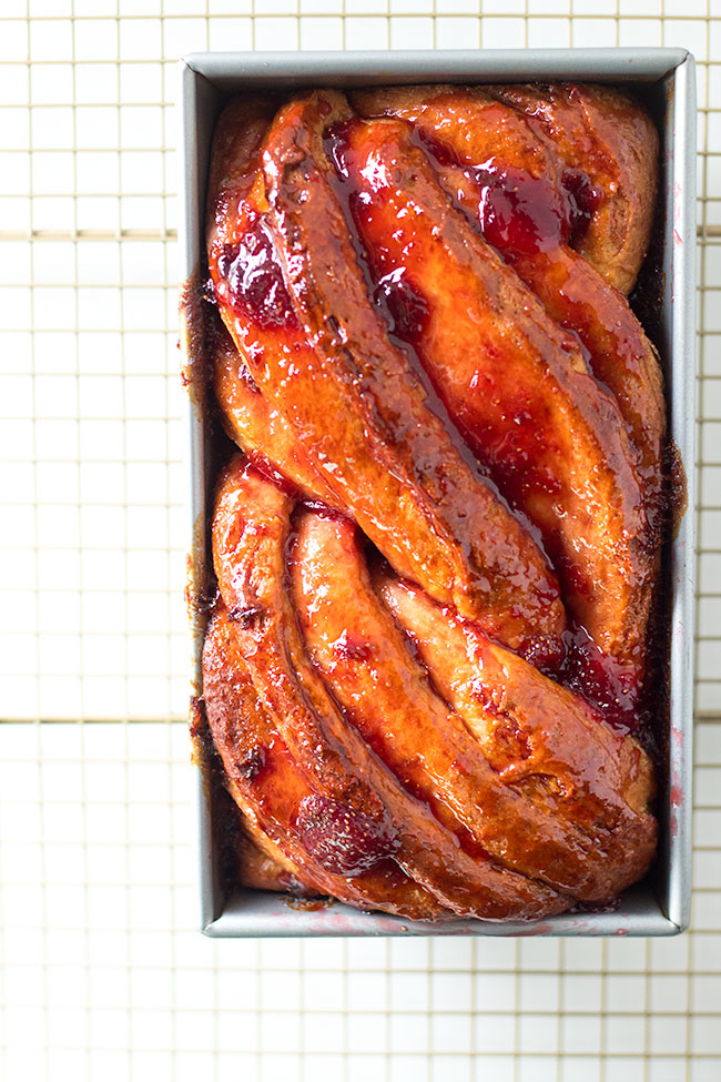 strawberry babka dripping with strawberry jam hot out of the oven